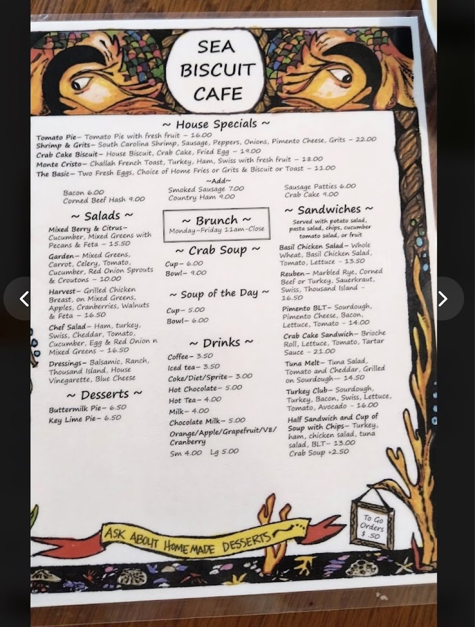 Cafe menu listing omelets, small plates, and biscuits.